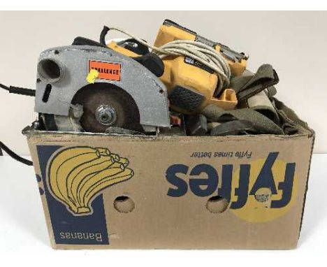 A box containing assorted power tools including hand saw, sander, woodworking planes, hard hats, work bench etc