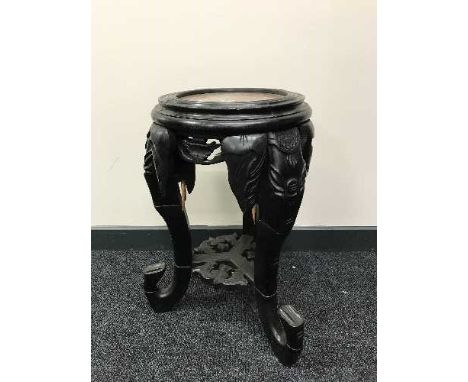 An oriental hardwood plant stand with rouge marble top on elephant trunk legs, height 56 cm
