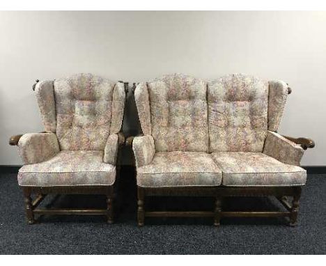 An Ercol two seater wing backed settee with matching armchair