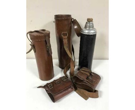 A basket of two cylindrical flask cases, one containing a flask and two leather cups 