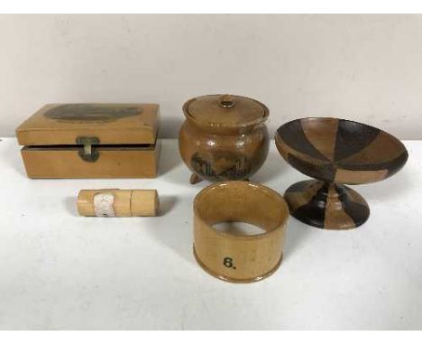 A box of five pieces of treen inc. St Johns Chapel lidded pot on three legs, Crown Hall Norfolk napkin ring, a Proprietary Co