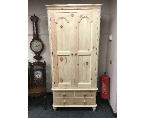A light pine double door wardrobe fitted with a drawer, width 94 cm