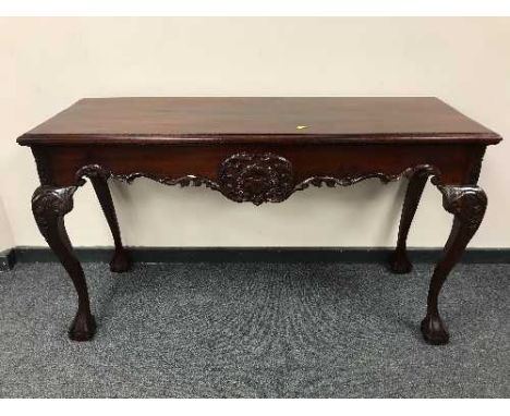 A Georgian style mahogany console table on claw and ball feet, width 141 cm