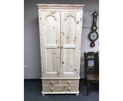 A light pine double door wardrobe fitted with a drawer, width 94 cm