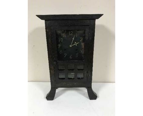 An early twentieth century oak mantel clock in the style of Liberty & Co