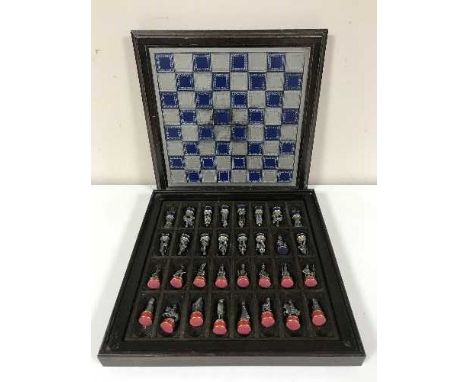 A chess set with pewter playing pieces