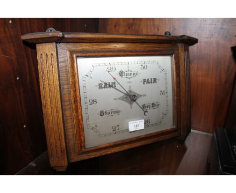 AN OAK CASED BAROMETER 
