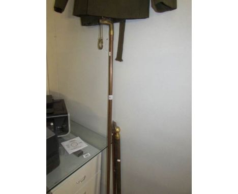 2 brass head walking sticks and a novelty pool cue stick