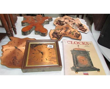 A quantity of copper clocks, a wooden clock and a book on clocks
