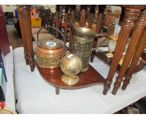 A heavy globe clock, a brass jug and a copper and brass biscuit barrel