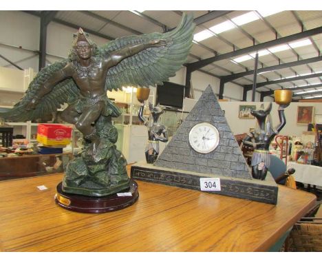 A 'Sphinx' mantel clock and a Juliana winged figure