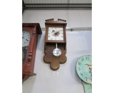 An oak effect kitchen wall clock