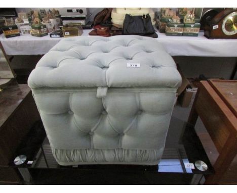 A green velour pouffe