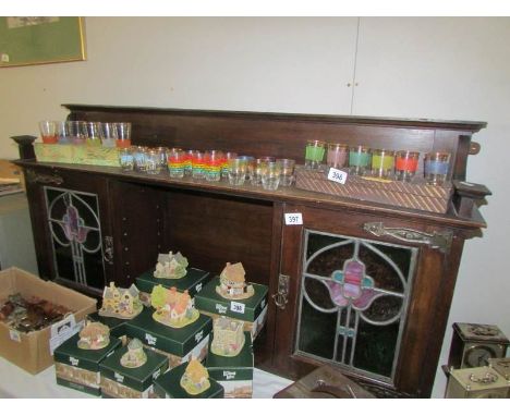 A dresser top with art nouveau glass doors and with key
