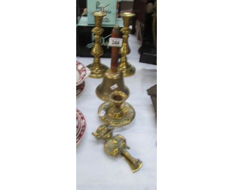 A brass Lincoln Imp door knocker, a pair of Victorian candlesticks, brass bell etc