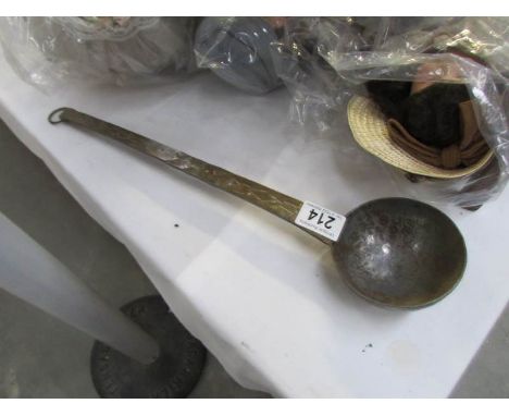 Vintage hammered copper ladle with a worn nickel plated finish