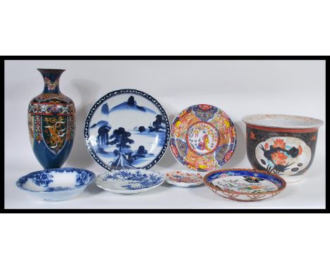 A collection of Chinese and Japanese ceramics to include a large planter decorated with peonies, blue and white charger etc. 