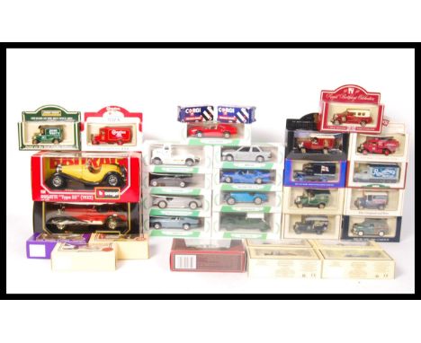 A collection of assorted scale diecast model vehicles to include; Corgi Mobil, Lledo, 1:24 scale BBurago (Burago) and Vanguar