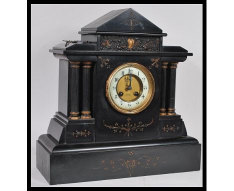 A Victorian 19th century 4 column slate mantel clock having inset 8 day movement&nbsp; striking on a gong. The large slate ca