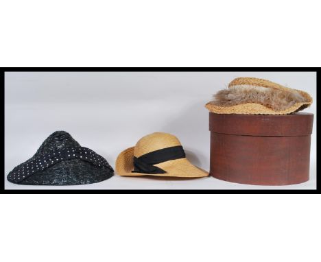 A group of three vintage / retro ladies hats to include a straw hat by Laura Ashley, another straw hat with ostrich feather a