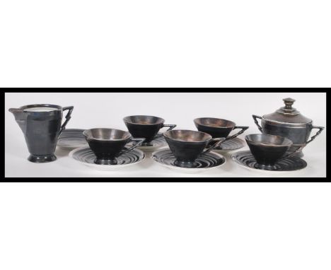 A early 20th century Art Deco sterling silver on porcelain coffee set / service consisting of five cups and six saucers, milk