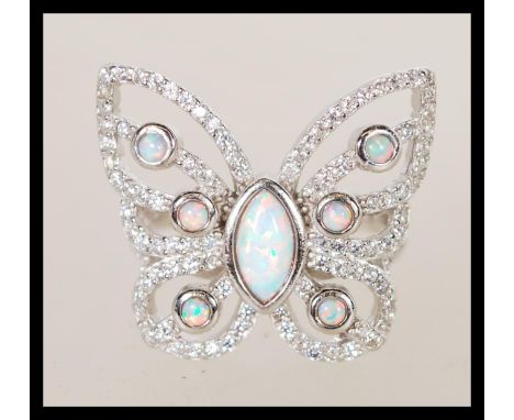 A sterling silver marcasite ring in the form of a butterfly having central opal panel. Weighs 6 grams size P.5.