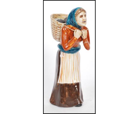 A vintage 20th Century pottery figure " The Peat Lady " The scottish pottery figure stamped for Coll Pottery Iles of Lewes, t