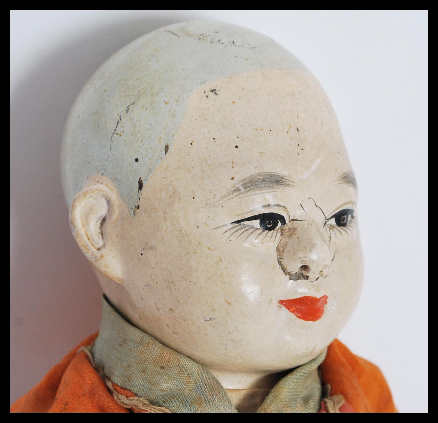 A vintage early 20th Century Chinese papiermâché and silk doll, the