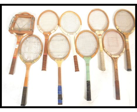 A group of vintage early to mid 20th Century sporting tennis rackets set in wooden frames.