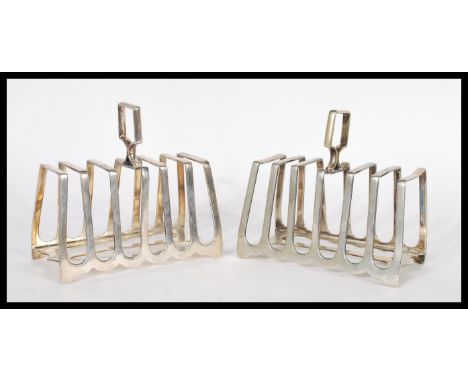 A pair of early 20th Century silver plated toast racks by Howson Brothers of graduating architectural form. Measures 12cm hig