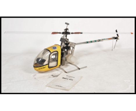 A German made schluter ' Bell 222 ' RC Radio Controlled scale helicopter having a fuel tank. Instruction still present.