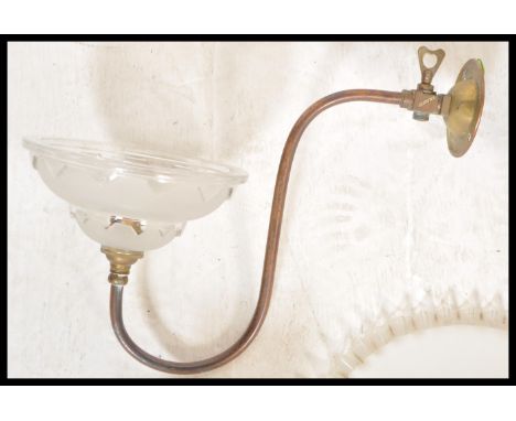 An early 20th century milk glass rise and fall chandelier light together with a pair of brass s-scroll wall lights having fro