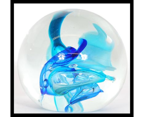 A vintage mid 20th Century studio art glass large paperweight having bubble control central design with shades of blue. Signe