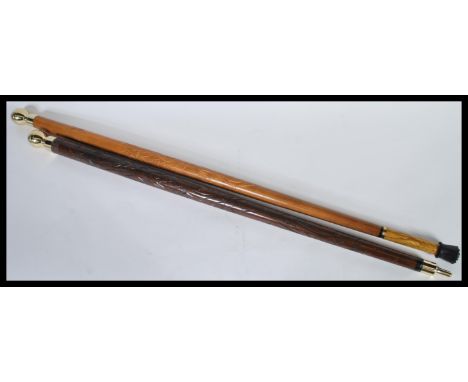 Two 20th Century walking stick canes with wooden shafts having carved decoration with brass orb handles to the tops. 93cm lon