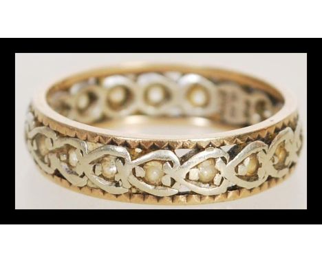 A hallmarked 9ct gold eternity ring of celtic influence set with white stones. Hallmarked Birmingham. Total weight 2.8g.