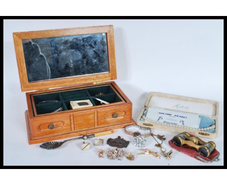 A collection of vintage costume jewellery to include brooches, a silver mourning brooch, bug brooch, silver cufflinks, opera 