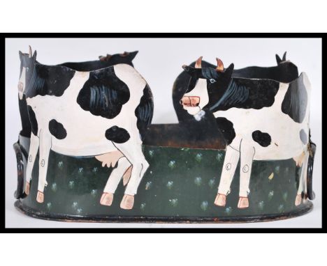 A vintage 20th Century folk art planter, upcycled from a Victorian tin hat tin. The tin cut out in silhouette in the form of 