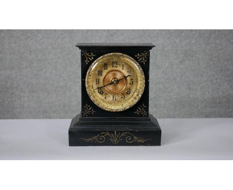 An early 20th century lacquered iron Ansonia mantle clock with gilt metal dial, gilded details and foliate design border. Wit