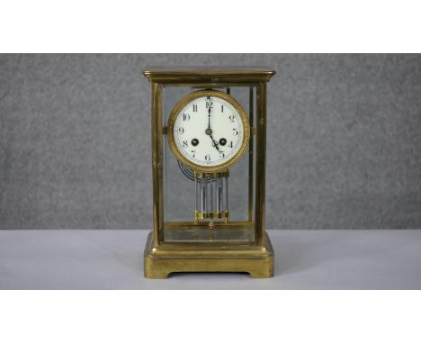 A 19th century French gilt brass and bevelled plate mercury pendulum mantle clock with white enamel dial with black Arabic nu