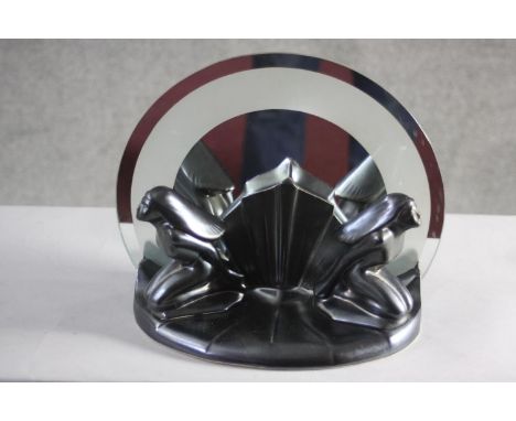 An Art deco style figural lamp with chrome banded glass disc shade. 