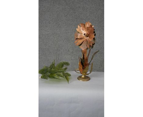 A sheet copper and brass embossed flower lamp along with a branch of green acrylic leaves on wire stems. H.18 W.8cm 