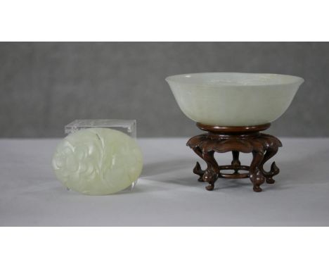 A 20th century Chinese carved celadon jade bowl and stand along with a carved jade plaque with pierced floral design. H.9 Dia