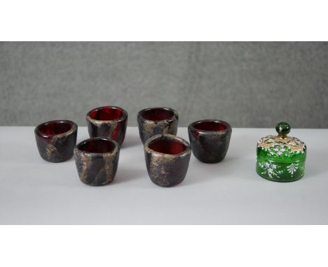 A collection of coloured glass. Including a set of six Manna gold foil ruby art glass cups, signed Manna and a Victorian Bohe