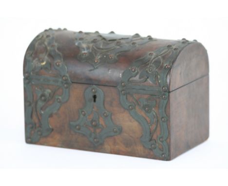 A Victorian burr walnut and brass mounted casket shaped tea caddy, the domed lid opening to reveal a two section interior, 23