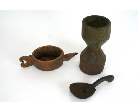 An antique treen vessel, having stylised decoration, tapering spout and loop handle, 21.5cm long; a small wooden ladle and a 