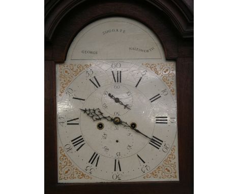 An oak long case clock, by George Suggate of Halesworth, the arched hood enclosing a painted dial, supporting an 8 day moveme