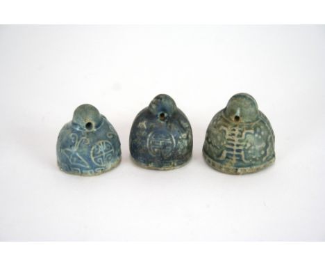 Three Chinese stoneware scroll weights, with foliate and symbol decoration, (possibly Ming)
