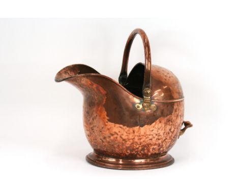 A 19th Century copper coal helmet, with swing handle