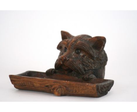 A Black Forest type carved wooden inkwell, in the form of a dog