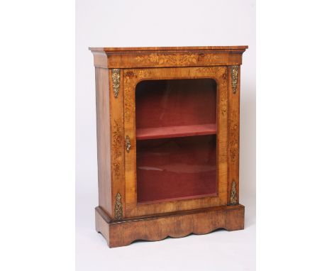 A Victorian walnut, rosewood cross-banded and inlaid pier cabinet, the fabric lined shelves enclosed by a glazed panelled doo